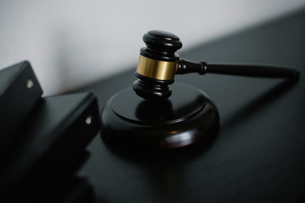 Offerings Close-up of a wooden gavel on a desk, symbolizing justice and legal authority.
